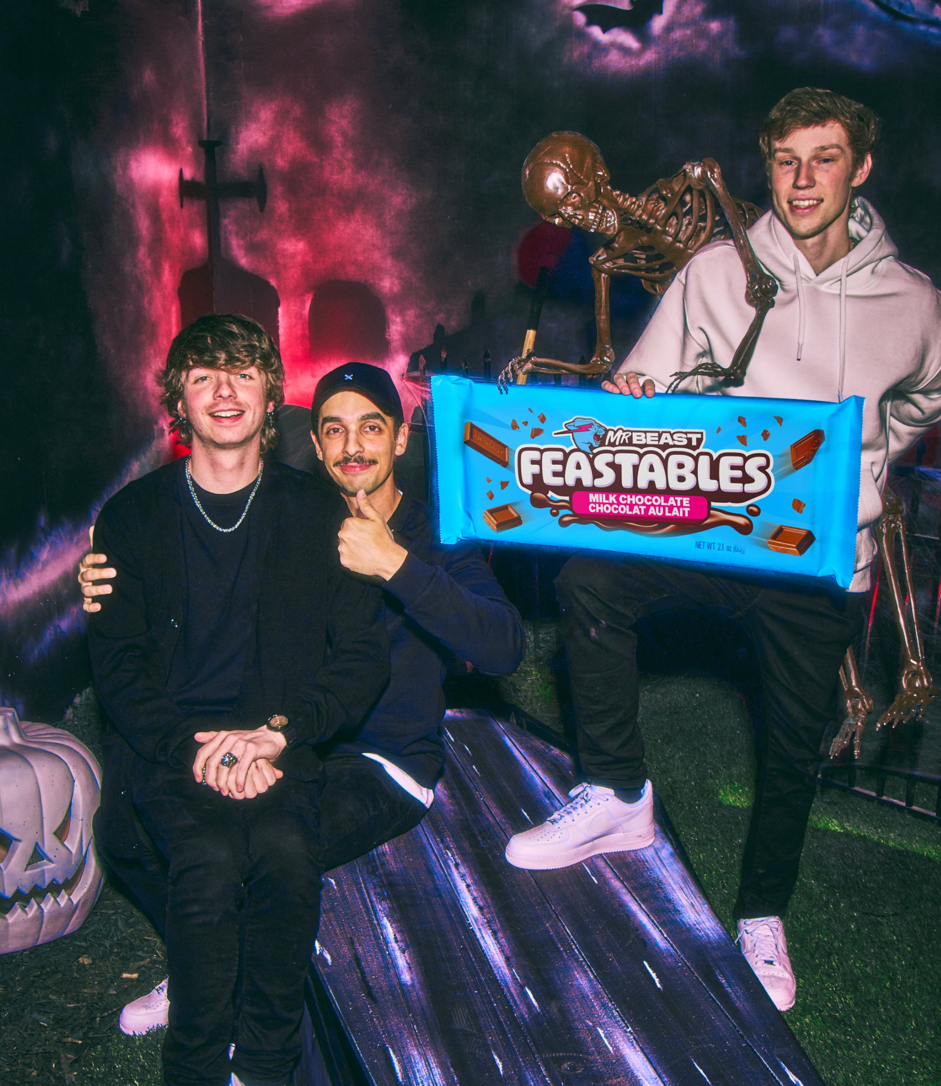 Karl, Tareq and Nolan in a graveyard with a skeleton trying to steal their giant Feastables chocolate bar