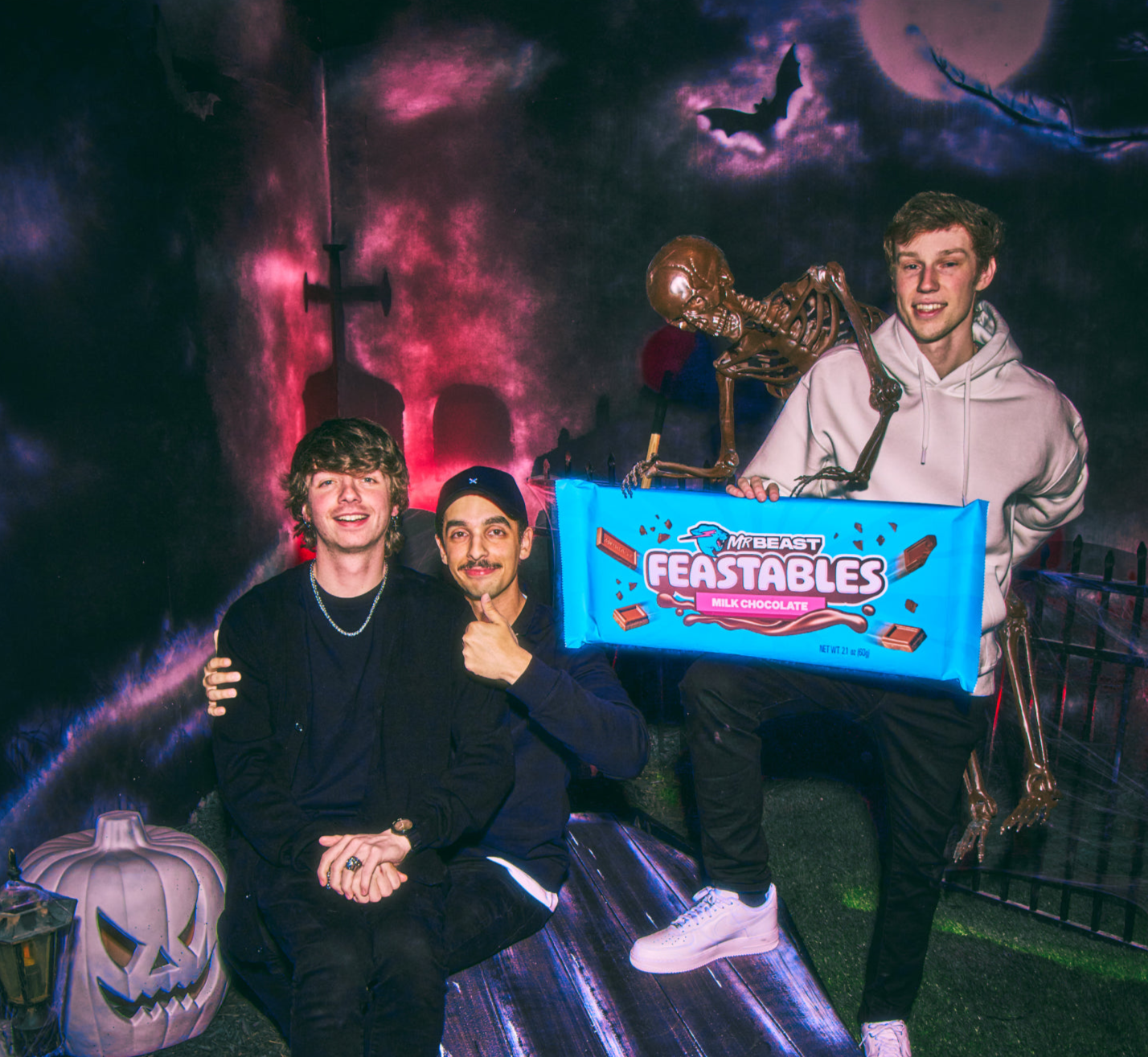 Karl, Tareq and Nolan in a graveyard with a skeleton trying to steal their giant Feastables chocolate bar