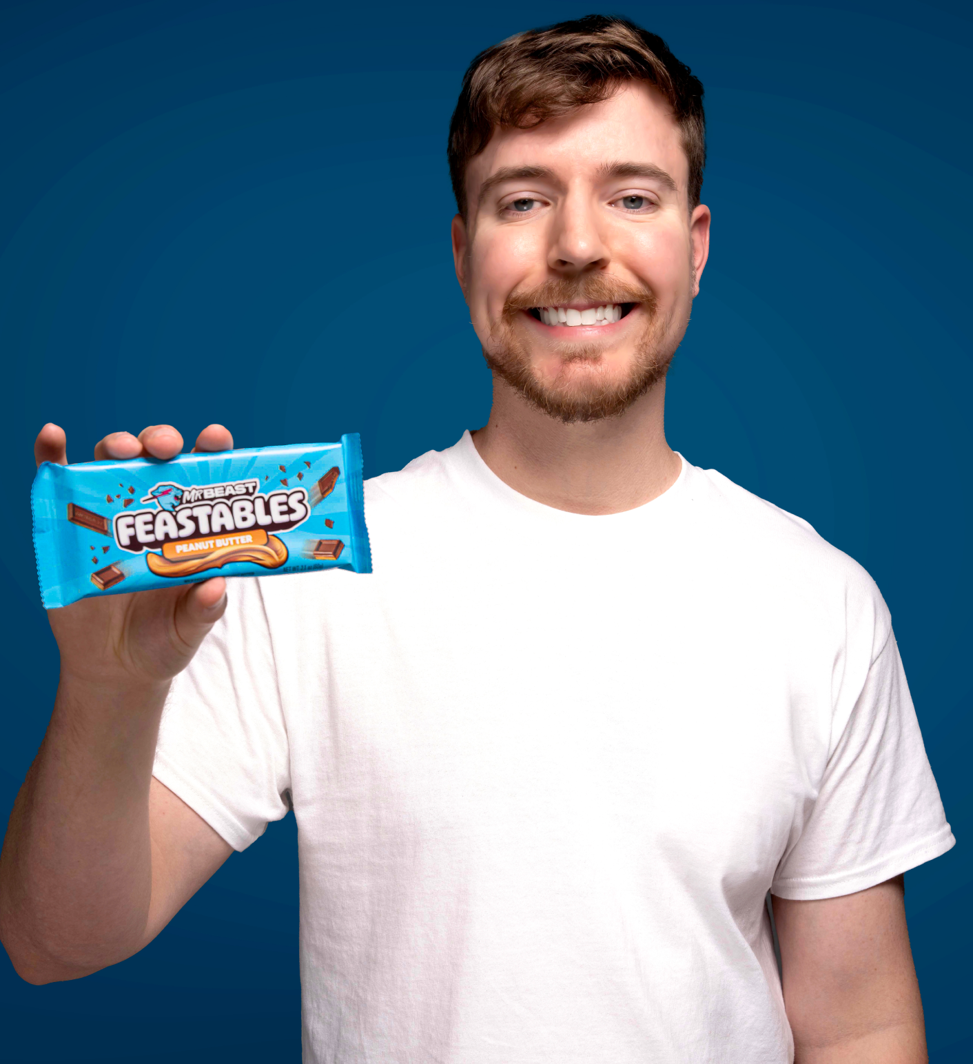 Pictured: MrBeast holding a Feastables peanut butter chocolate bar